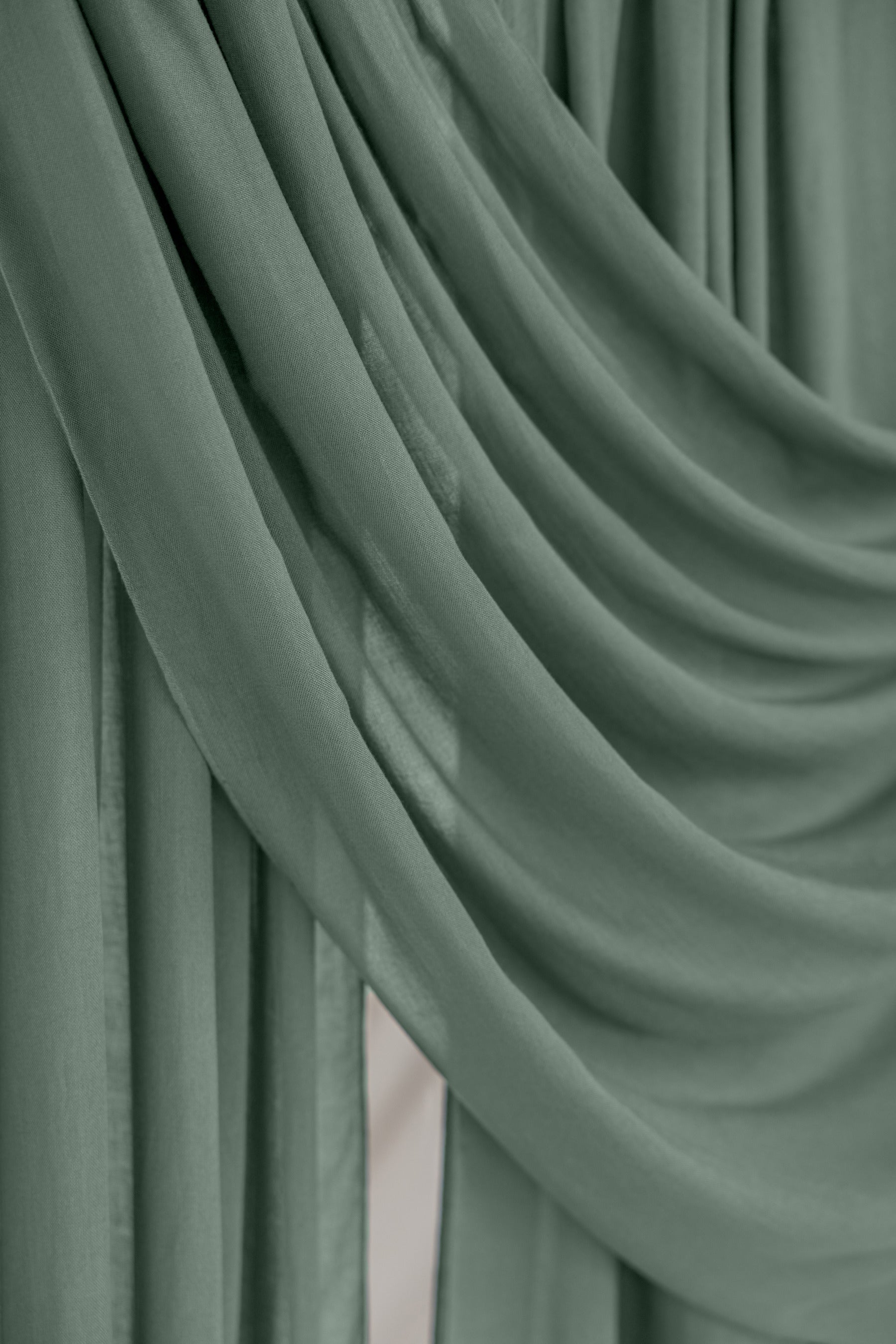 Close-up of green hijab fabric with folds