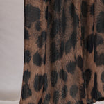 Chocolate leopard print fabric on a plain background