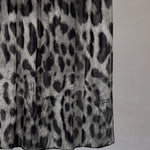 Black and white leopard print fabric with a plain background
