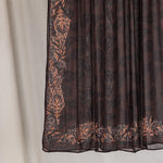 Folded Chocolate Paisley hijab hanging to show print details.