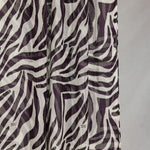 A close-up of the Zebra scarf that shows the scaling and detail of the white base and deep berry stripes. 