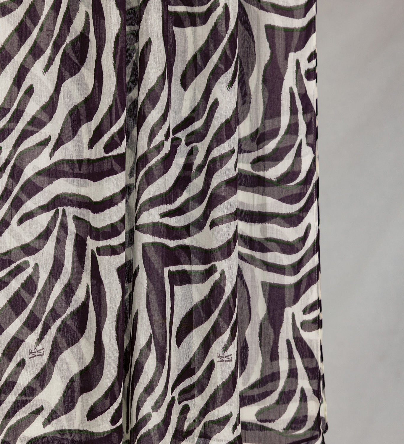 A close-up of the Zebra scarf that shows the scaling and detail of the white base and deep berry stripes. 