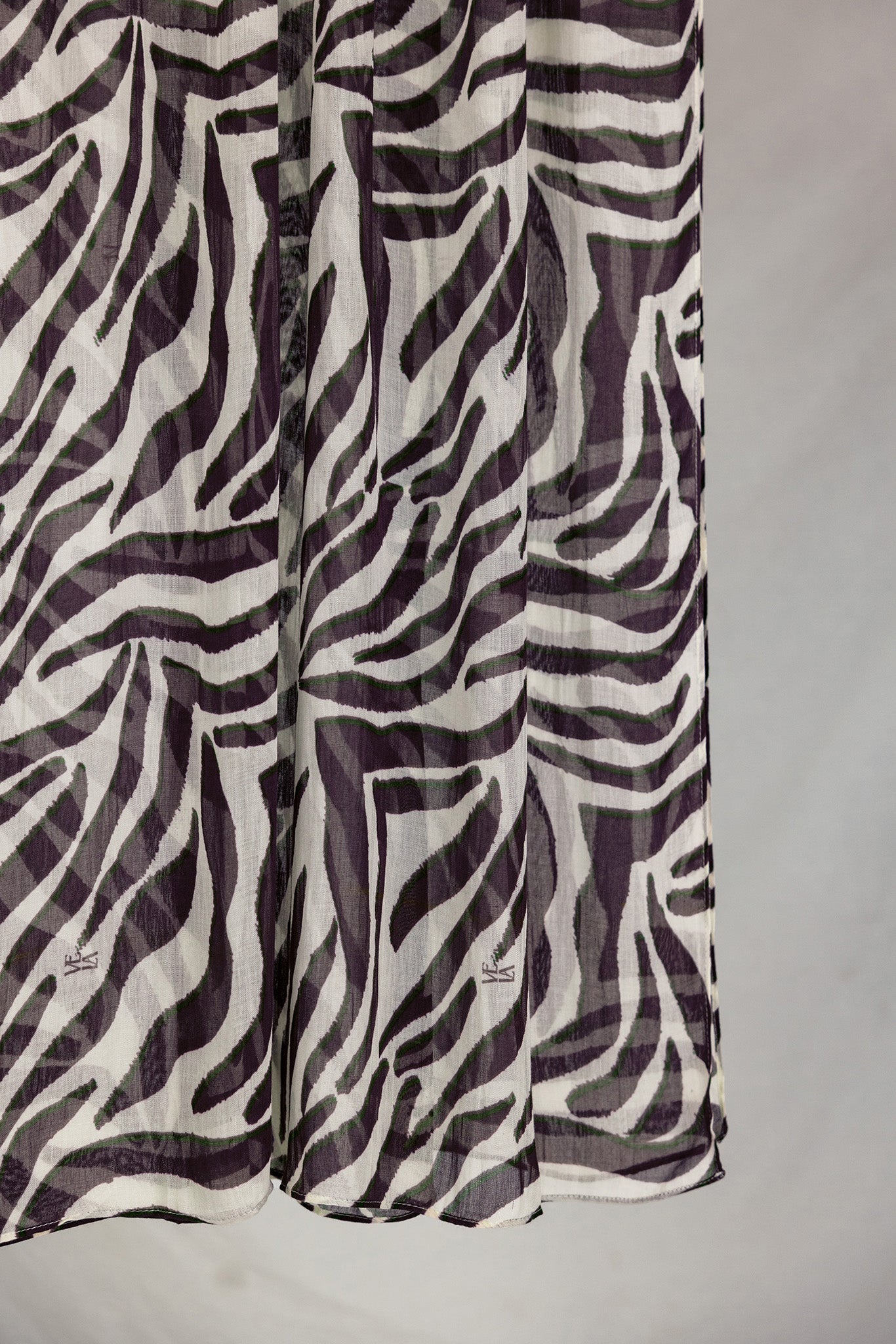 A close-up of the Zebra scarf that shows the scaling and detail of the white base and deep berry stripes. 