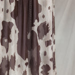 Close-up product shot of Prairie Hide, showcasing it's cream base and brown randomized splotches like a cow hide. 