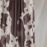 Close-up product shot of Prairie Hide, showcasing it's cream base and brown randomized splotches like a cow hide. 