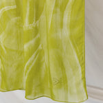 Lime green sediment print hijab draped in front a white background