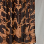 Product shot of Wild Savanna that shows a close-up of the animal-inspired print with peaches/oranges and deep browns. 
