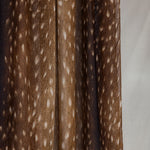 A close-up of the product hanging that shows the change in tones of the browns in the print and white speckles like a fawn.