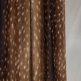 A close-up of the product hanging that shows the change in tones of the browns in the print and white speckles like a fawn.