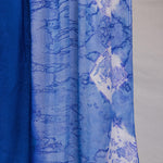Blue hijab with white abstract shell patterns on a white background