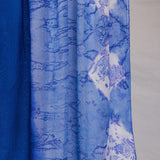 Blue hijab with white abstract shell patterns on a white background