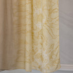 Brown beige hijab with yellow abstract pattern on a plain background