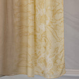Brown beige hijab with yellow abstract pattern on a plain background