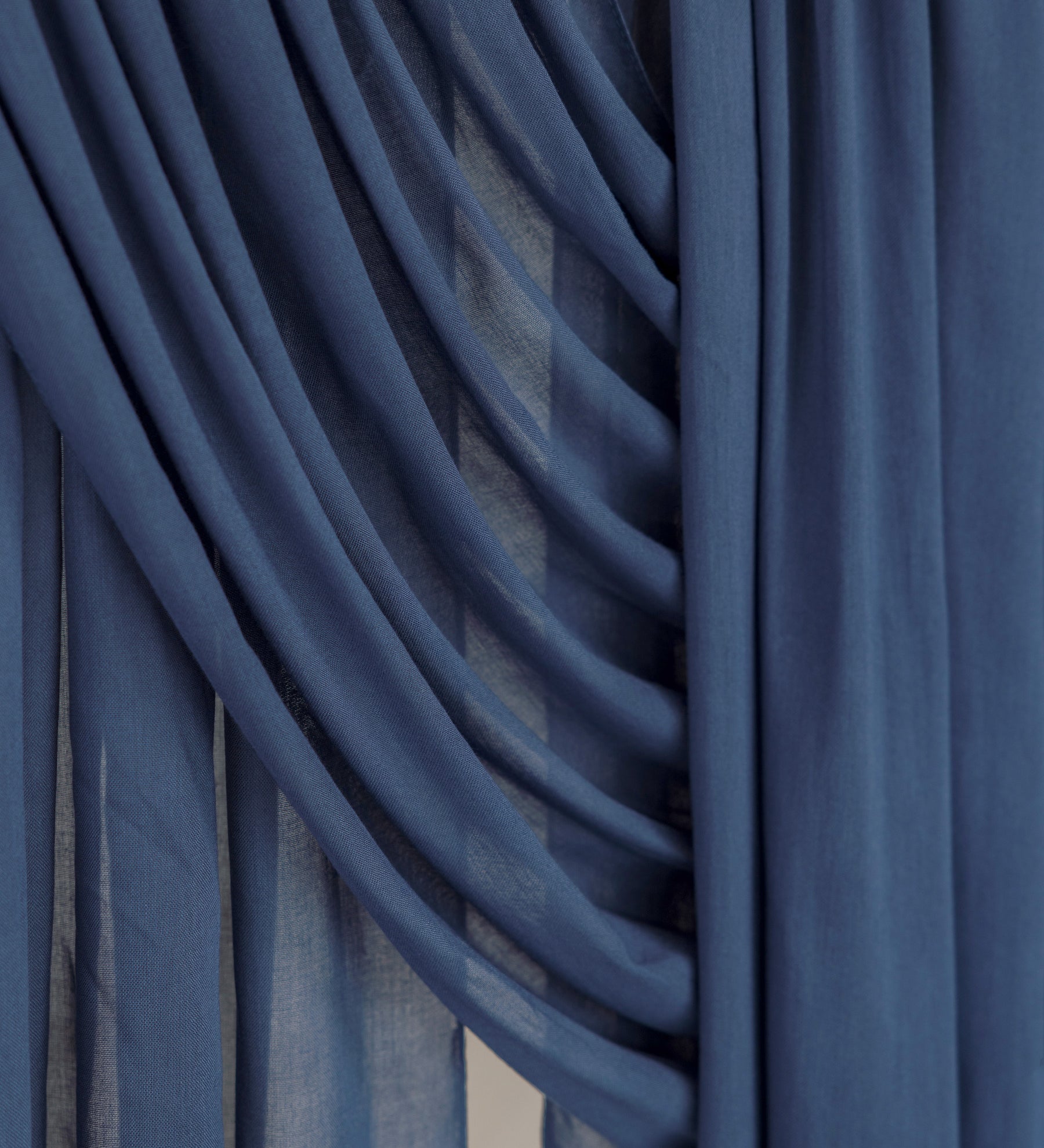 Close-up of blue hijab fabric with draped layers