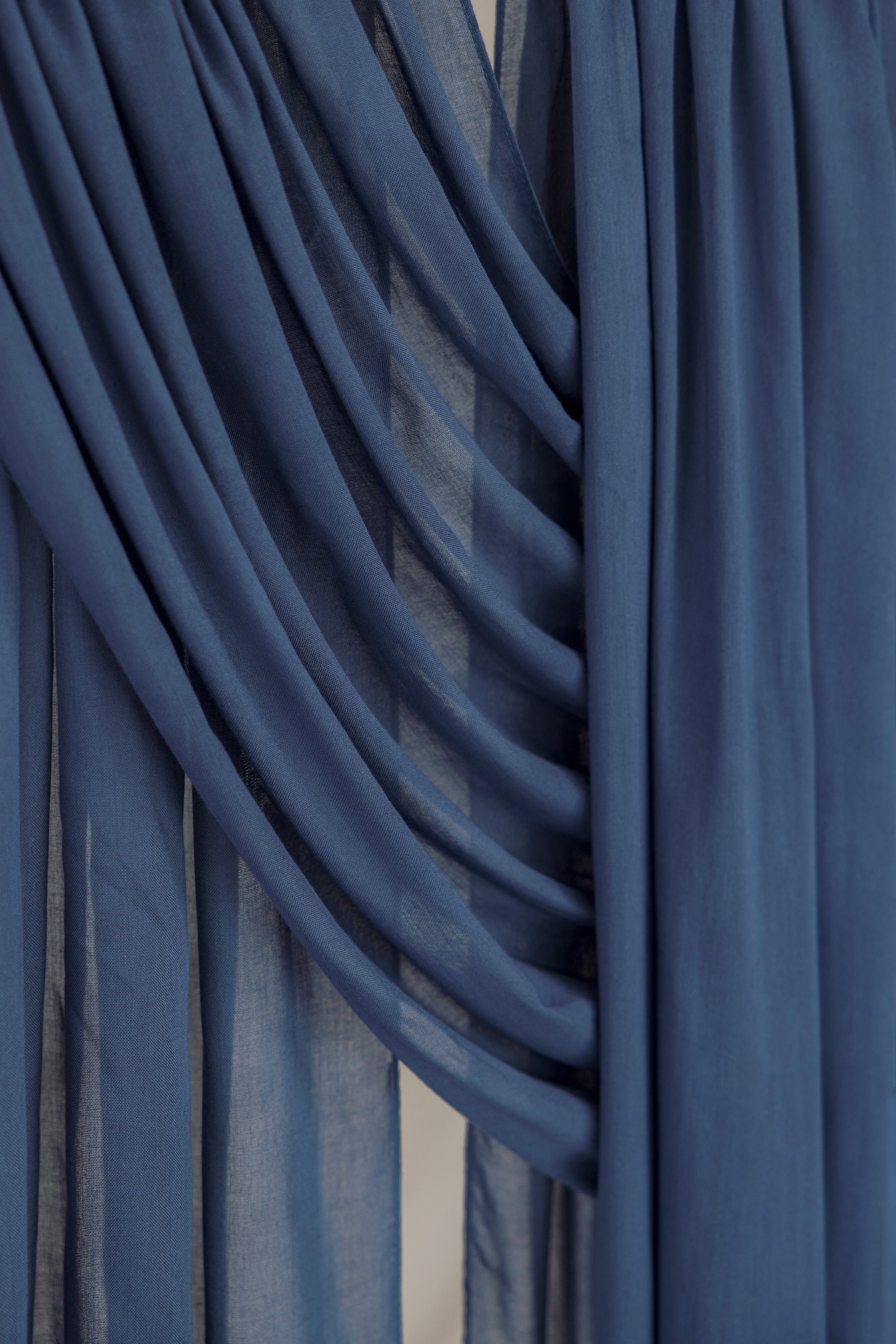 Close-up of blue hijab fabric with draped layers