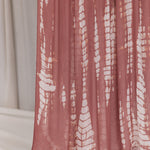 Pink ripple printed hijab draped in front of a neutral background