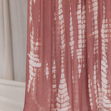 Pink ripple printed hijab draped in front of a neutral background