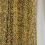 Close-up product detail shot of the Golden Cobra scarf, showcasing the snakeskin-like design and golden tones. 
