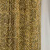 Close-up product detail shot of the Golden Cobra scarf, showcasing the snakeskin-like design and golden tones. 