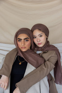 Two individuals wearing taupe-colored hijabs.