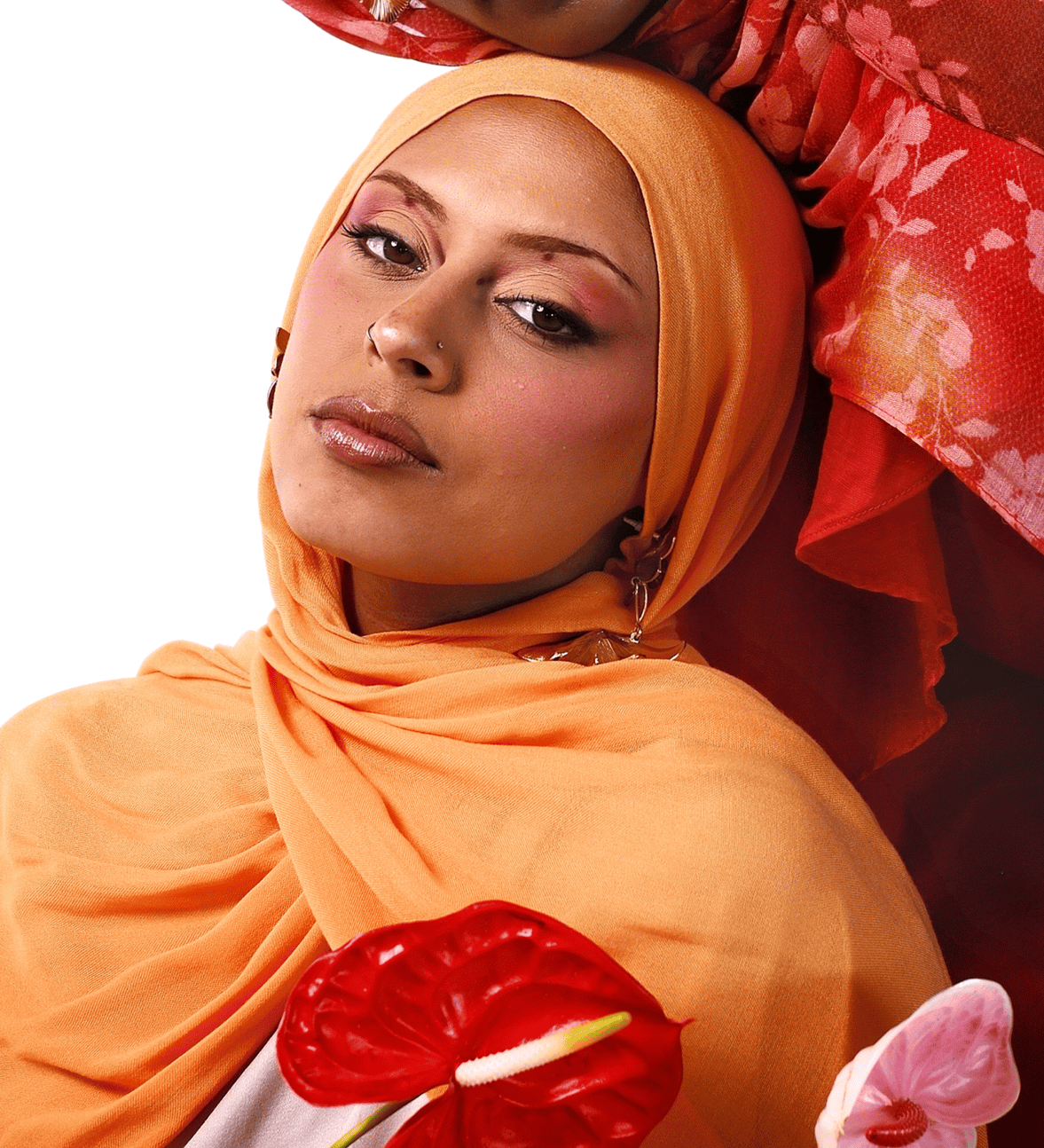 Two women wearing colorful headscarves with flowers in their hands on a white background