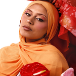 Two women wearing colorful headscarves with flowers in their hands on a white background