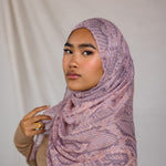 Close up of model in pink and purple snakeskin inspired print. Shows pattern of the hijab. 