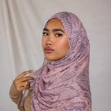 Close up of model in pink and purple snakeskin inspired print. Shows pattern of the hijab. 