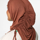 Woman wearing a canyon brown ruching hijab with a taupe top