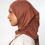 Woman wearing a canyon brown ruching hijab with a taupe top