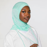 woman wearing sea glass ruching hijab with white top