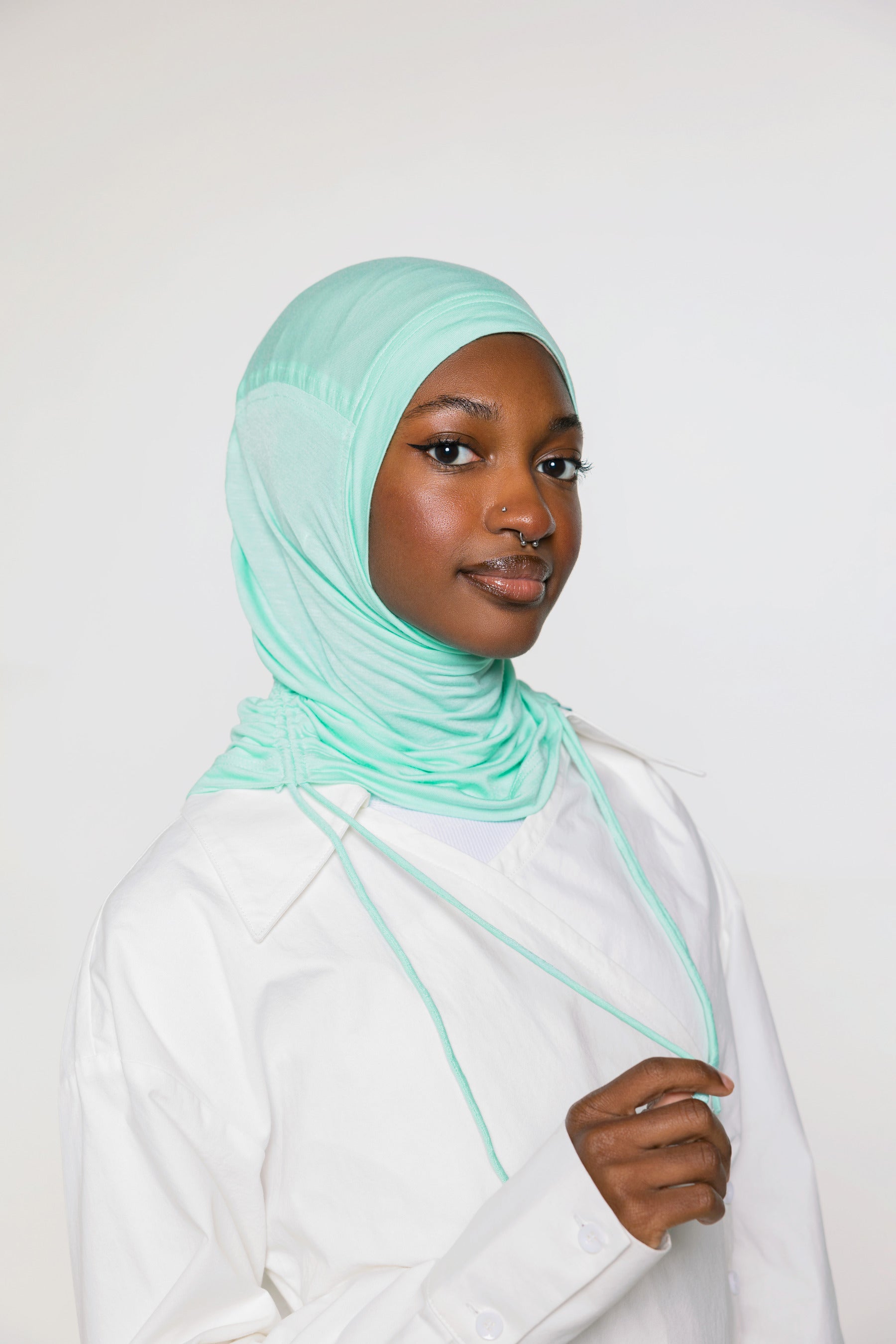 woman wearing sea glass ruching hijab with white top