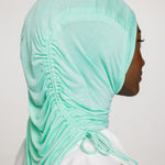 woman wearing sea glass ruching hijab with white top