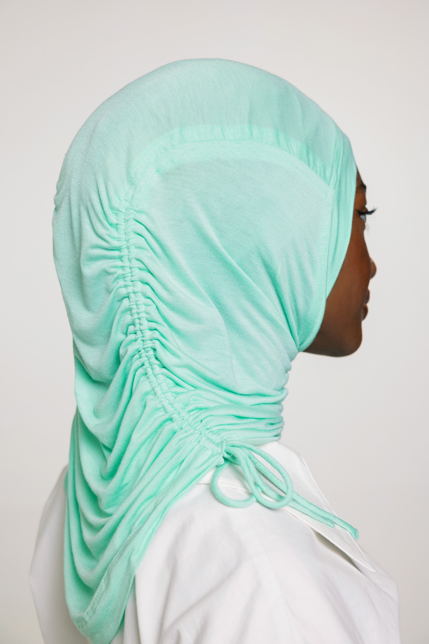 woman wearing sea glass ruching hijab with white top