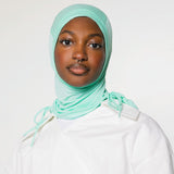 woman wearing sea glass ruching hijab with white top