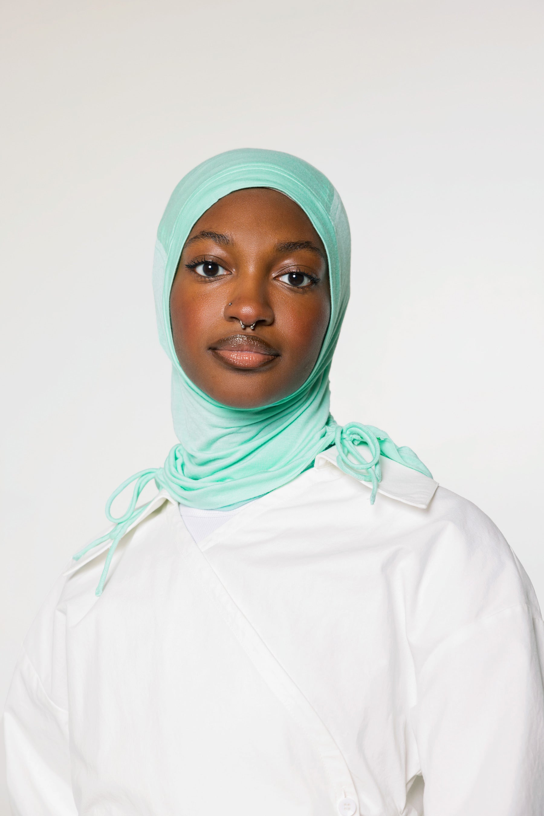 woman wearing sea glass ruching hijab with white top