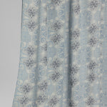 Light blue floral patterned fabric on a plain background