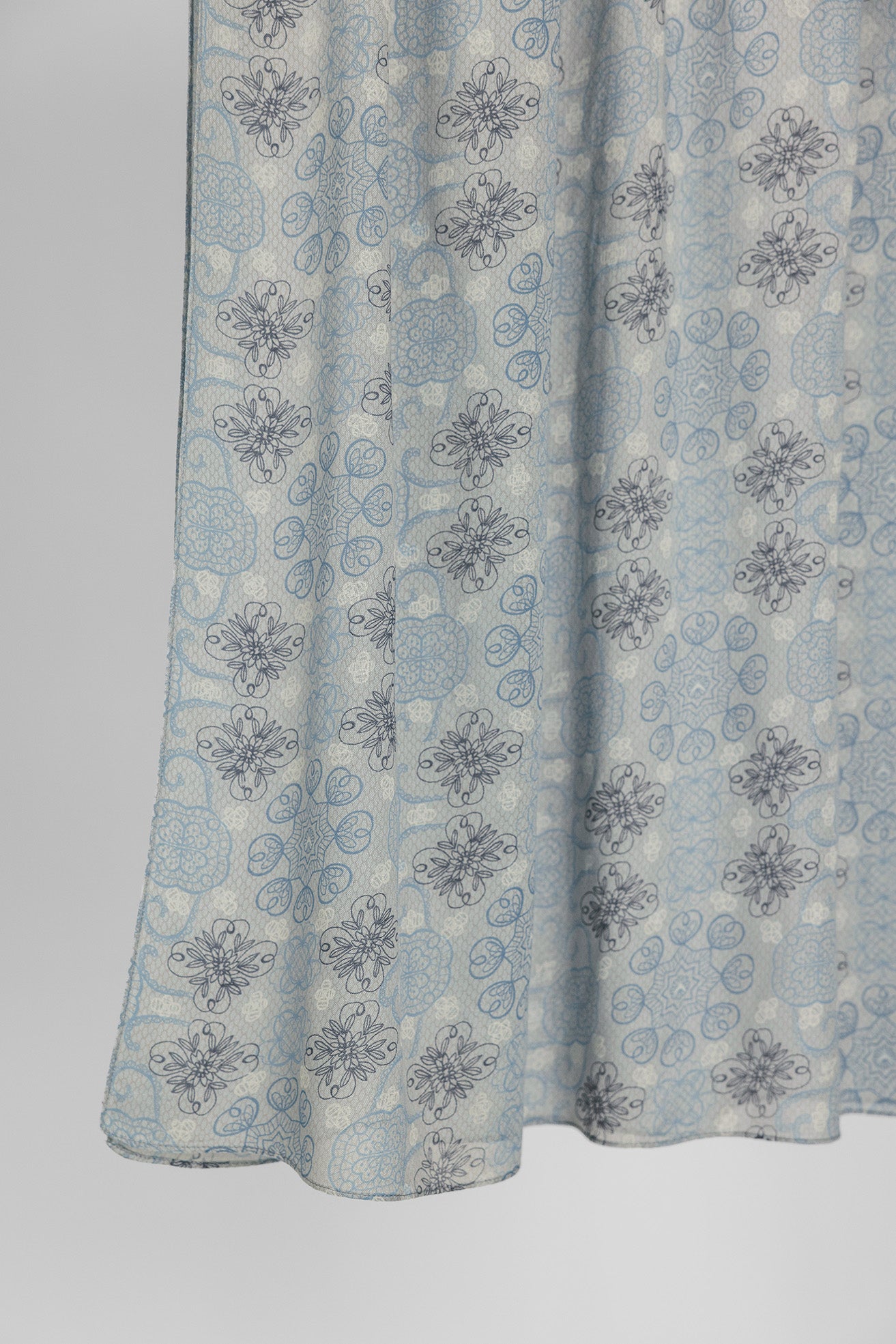 Light blue floral patterned fabric on a plain background