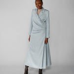 Woman wearing a silver ruched abaya with a white background