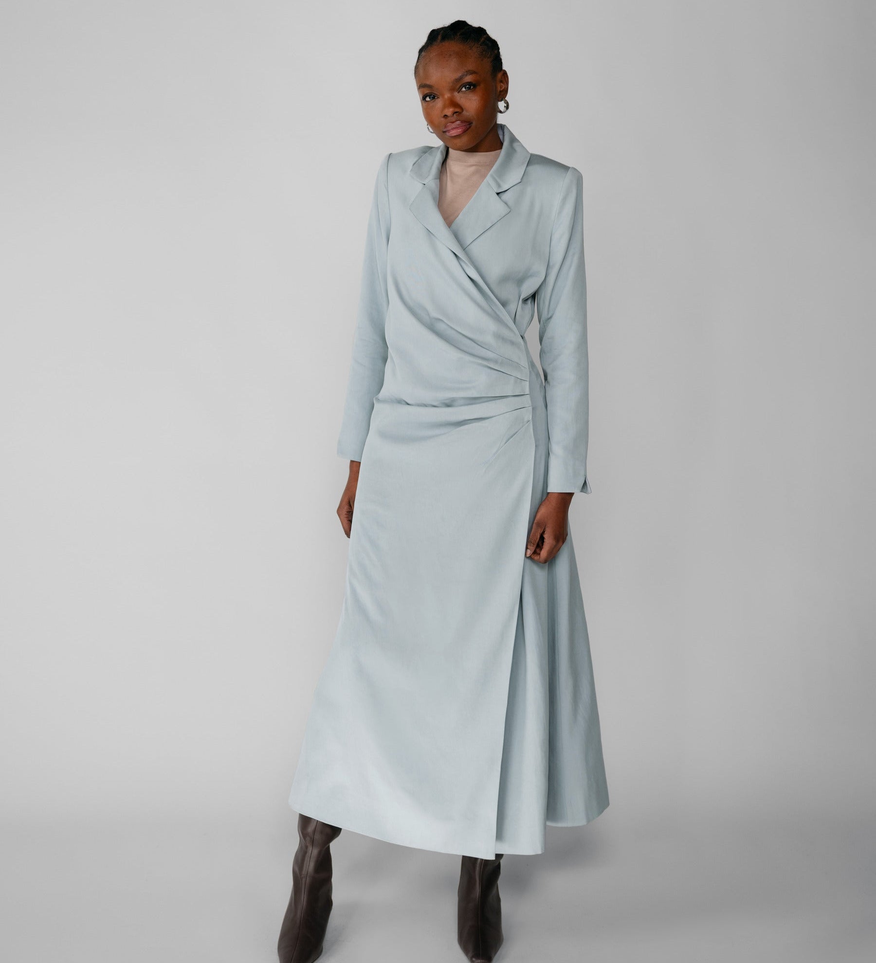 Woman wearing a silver ruched abaya with a white background