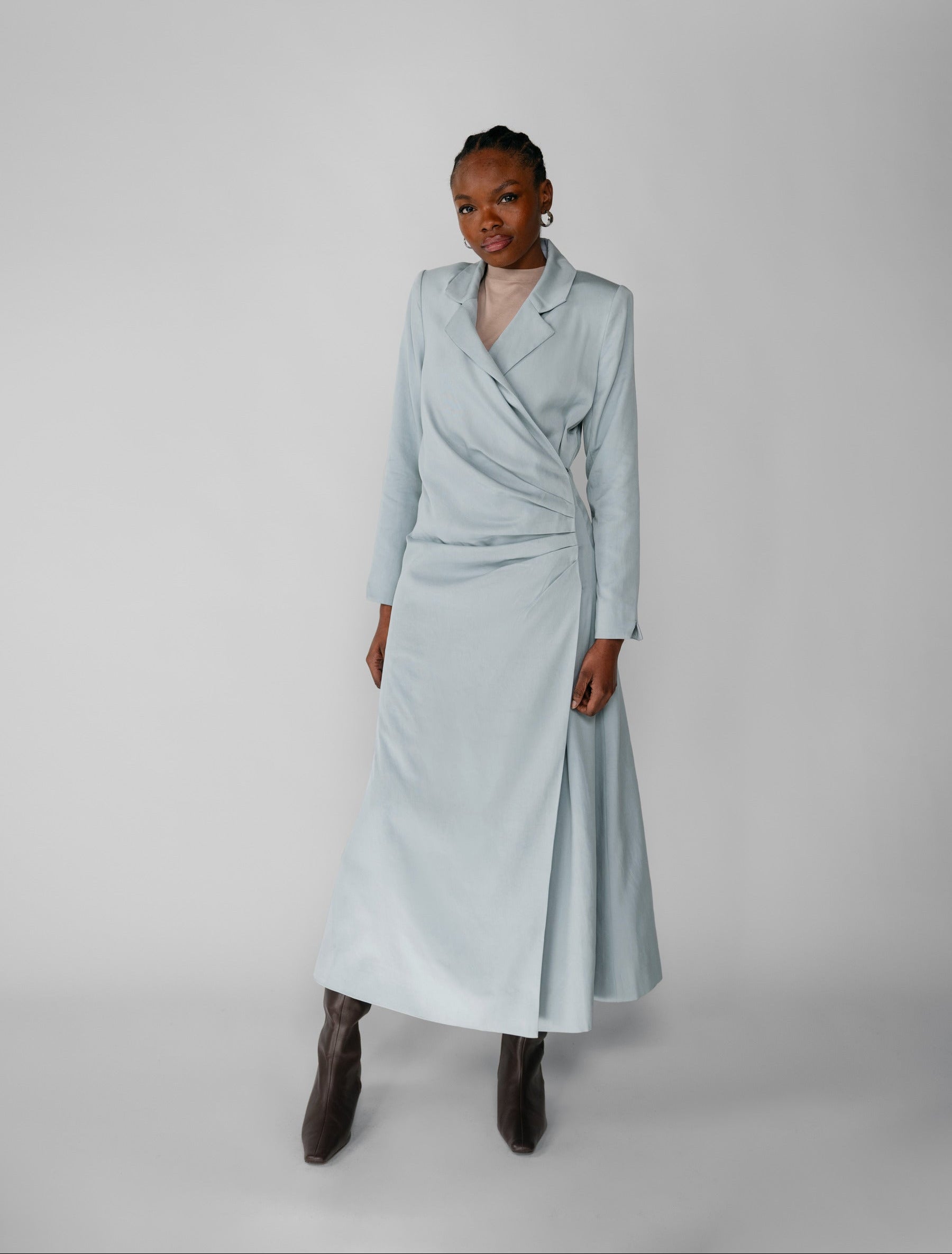 Woman wearing a silver ruched abaya with a white background