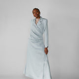Woman wearing a silver ruched abaya with a white background