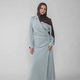 Woman wearing a silver ruched abaya with a white background