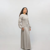 Woman wearing a light gray outfit on a white background