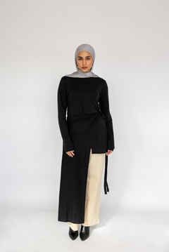 Loose-fitting top with a soft drape and subtle high-low hem for easy layering.