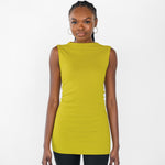 Woman wearing a sleeveless citrine yellow top on a white background