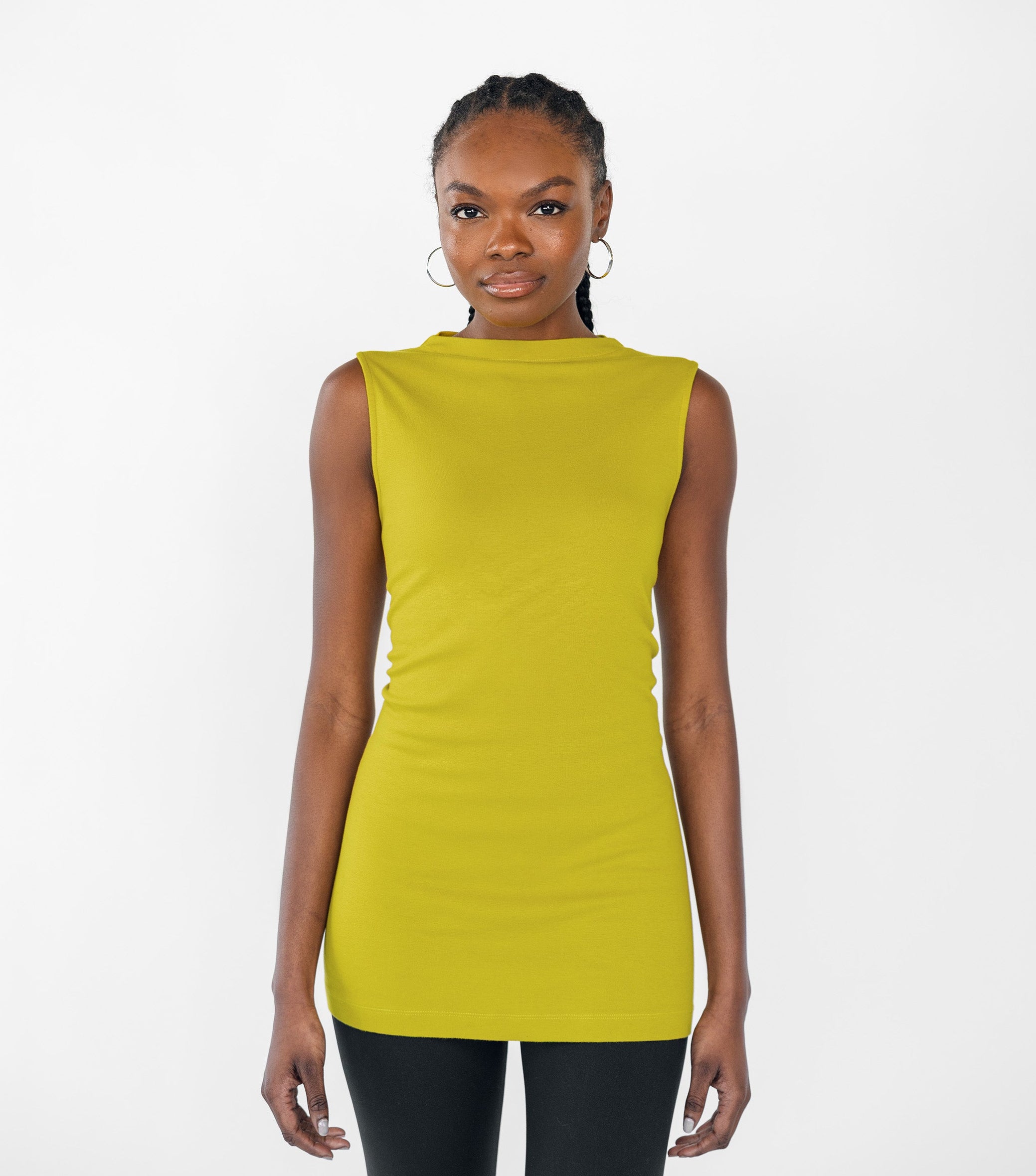 Woman wearing a sleeveless citrine yellow top on a white background
