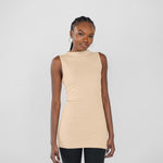 Woman wearing a beige sleeveless top against a plain background