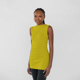 Woman wearing a sleeveless citrine yellow top on a white background