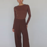 Model wearing brown top and brown pants with truffle stripe.